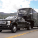 black ford pickup truck towing a camping trailer